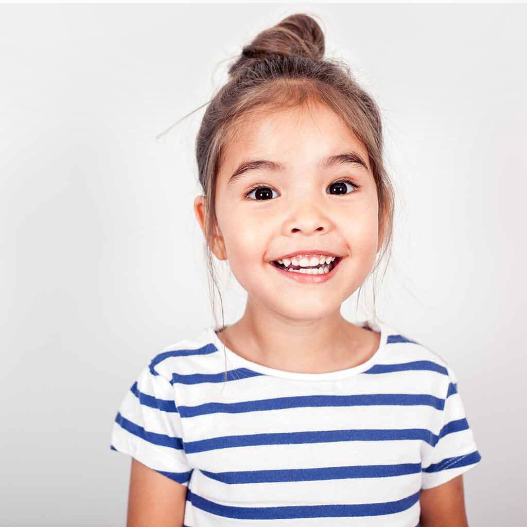 Young girl in a striped shirt smiling